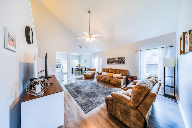 10627 Fire Sage Dr, Humble, TX 77396 - living area with high vaulted ceiling, plenty of natural light, wood finished floors, and a ceiling fan
