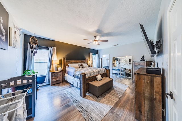 10627 Fire Sage Dr, Humble, TX 77396 - bedroom featuring wood finished floors, a textured ceiling, and ceiling fan