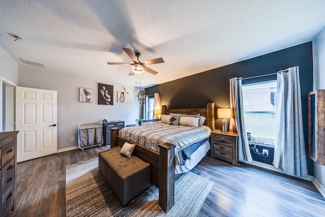 10627 Fire Sage Dr, Humble, TX 77396 - bedroom featuring wood finished floors, ceiling fan, and a textured ceiling