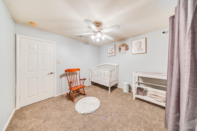 10627 Fire Sage Dr, Humble, TX 77396 - carpeted bedroom featuring a crib and ceiling fan
