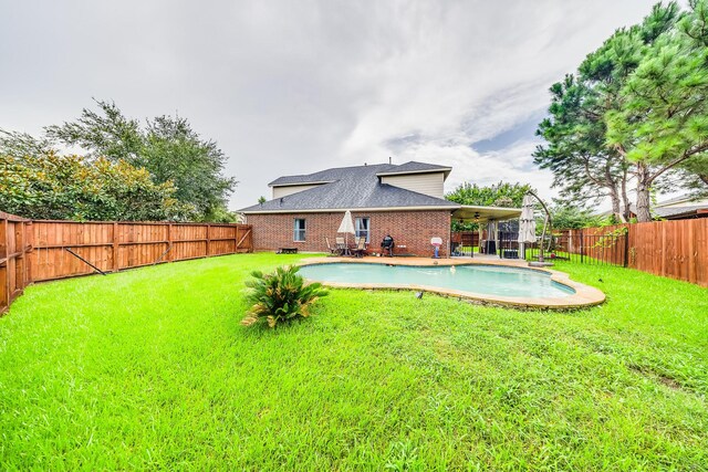 10627 Fire Sage Dr, Humble, TX 77396 - back of property featuring a fenced backyard, a patio area, brick siding, and a shingled roof