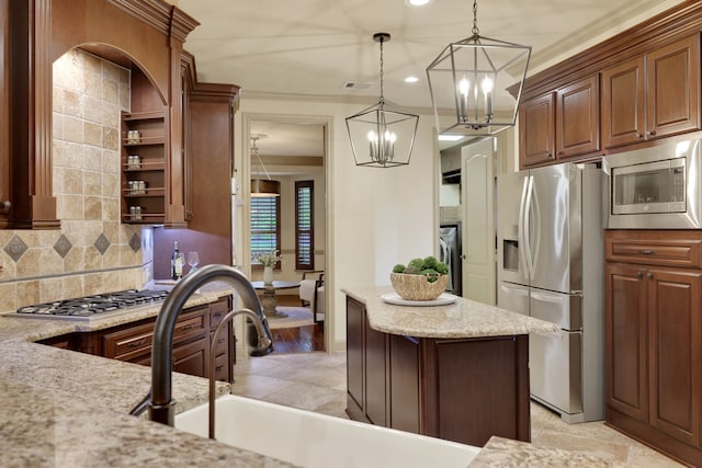 21311 Fairhaven Meadow Dr, Cypress, TX 77433 - kitchen featuring stainless steel appliances, a chandelier, decorative backsplash, pendant lighting, and crown molding