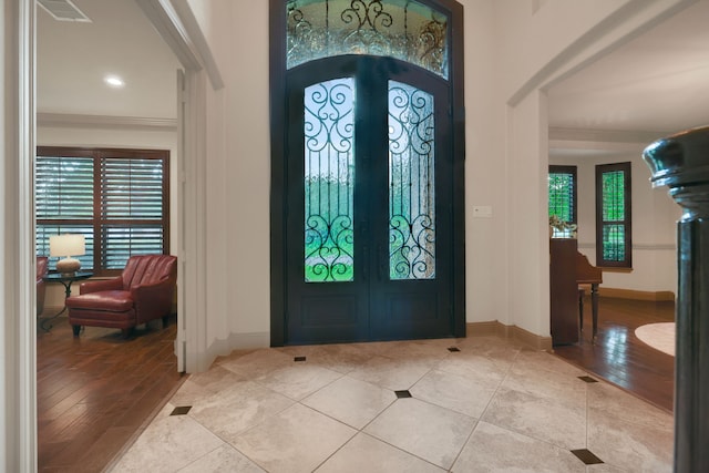 21311 Fairhaven Meadow Dr, Cypress, TX 77433 - foyer entrance with plenty of natural light, french doors, arched walkways, and light tile patterned flooring