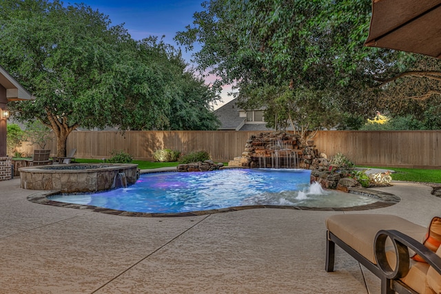 21311 Fairhaven Meadow Dr, Cypress, TX 77433 - pool at dusk featuring a fenced backyard, a patio area, and a pool with connected hot tub
