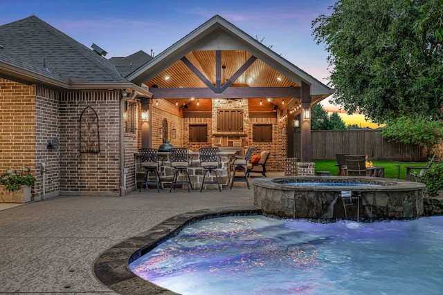 21311 Fairhaven Meadow Dr, Cypress, TX 77433 - pool at dusk featuring a patio and a pool with connected hot tub
