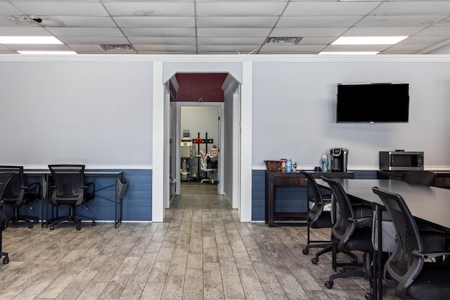 902 51st St, Galveston, TX 77551 - office space with a drop ceiling, wood finished floors, arched walkways, a wainscoted wall, and crown molding