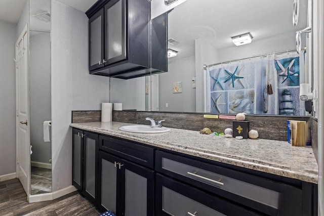 902 51st St, Galveston, TX 77551 - full bath featuring wood finished floors, vanity, and a shower with curtain
