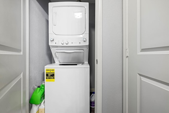 902 51st St, Galveston, TX 77551 - laundry room featuring estacked washer and dryer and a textured wall