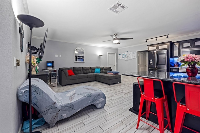 902 51st St, Galveston, TX 77551 - living area featuring ornamental molding, a ceiling fan, and wood finish floors