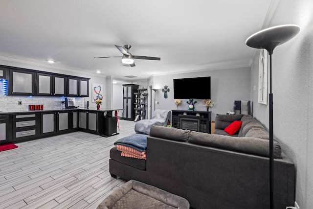 902 51st St, Galveston, TX 77551 - living area featuring crown molding, a ceiling fan, and light wood finished floors