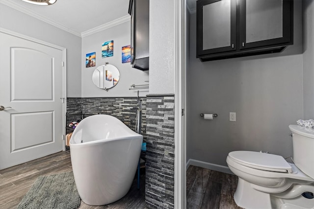 902 51st St, Galveston, TX 77551 - full bath with a freestanding tub, ornamental molding, wood finished floors, wainscoting, and tile walls