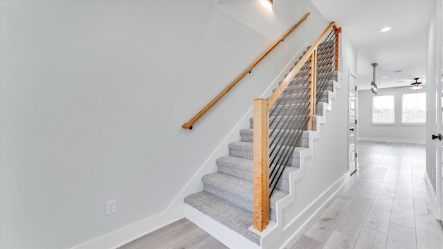 6902 Apollo St, Houston, TX 77091 - stairway featuring a ceiling fan, wood finished floors, and recessed lighting