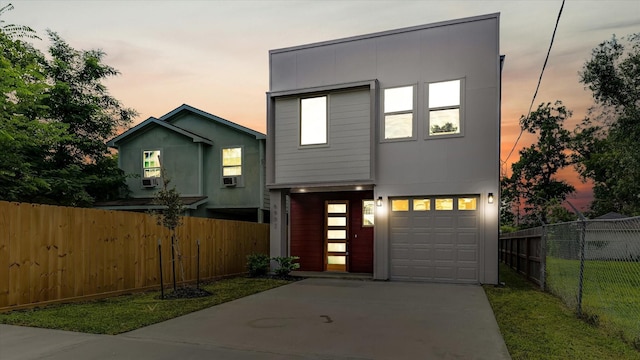 6902 Apollo St, Houston, TX 77091 - contemporary house with concrete driveway, an attached garage, and cooling unit