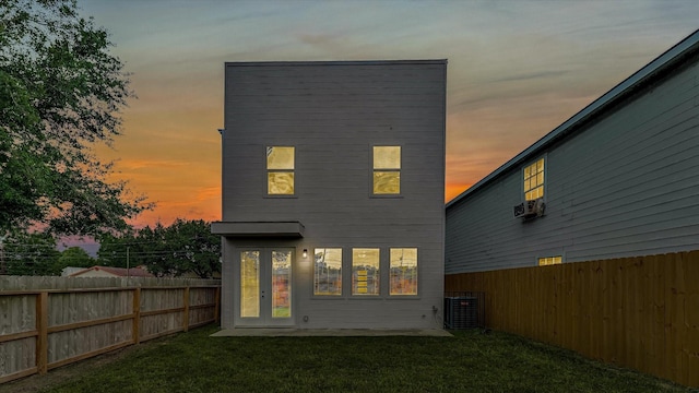 6902 Apollo St, Houston, TX 77091 - back of property at dusk featuring a fenced backyard and french doors