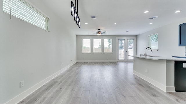 6902 Apollo St, Houston, TX 77091 - unfurnished living room with healthy amount of natural light, recessed lighting, light wood-style flooring, and a ceiling fan