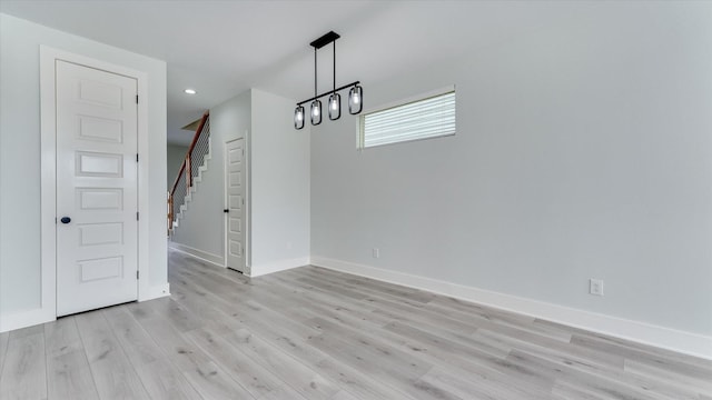 6902 Apollo St, Houston, TX 77091 - unfurnished dining area with light wood finished floors, stairs, and recessed lighting