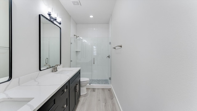 6902 Apollo St, Houston, TX 77091 - bathroom with wood finished floors, a shower stall, double vanity, and recessed lighting