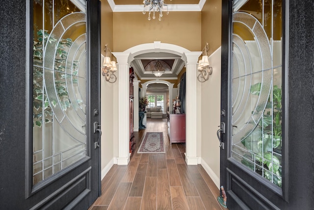 13306 Boca Raton Dr, Houston, TX 77069 - entrance foyer featuring decorative columns, ornamental molding, a chandelier, arched walkways, and dark wood-type flooring