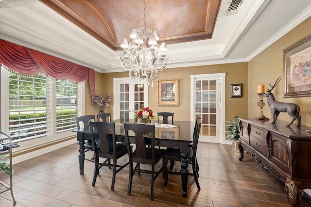 13306 Boca Raton Dr, Houston, TX 77069 - dining space with a tray ceiling, a chandelier, ornamental molding, and dark wood-type flooring