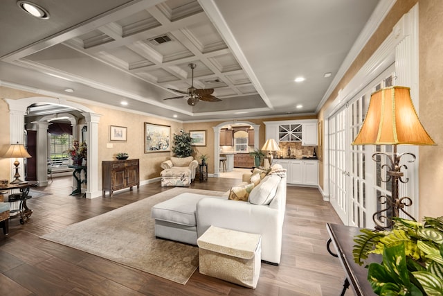 13306 Boca Raton Dr, Houston, TX 77069 - living area with ornate columns, arched walkways, crown molding, ceiling fan, and dark wood finished floors