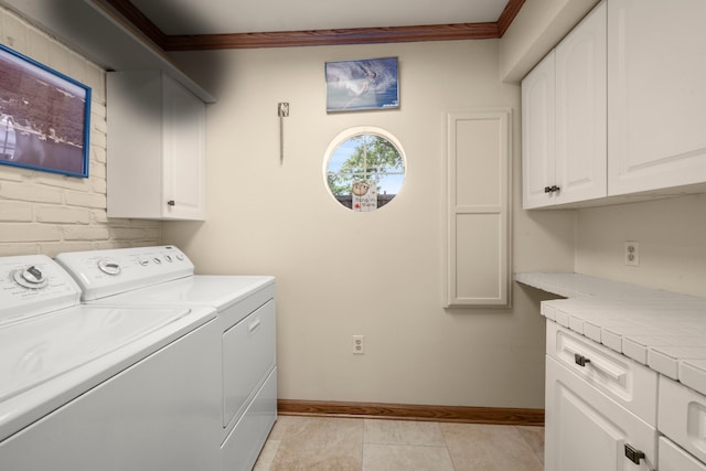 13306 Boca Raton Dr, Houston, TX 77069 - laundry room featuring washing machine and clothes dryer, cabinet space, ornamental molding, and light tile patterned floors