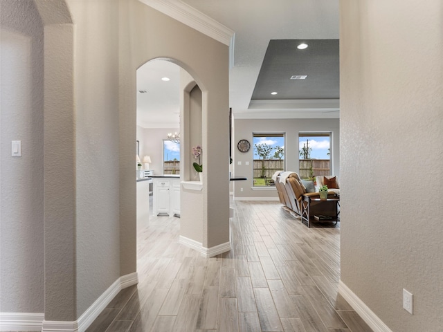 103 Lakeshore Ct, Clute, TX 77531 - hallway featuring ornamental molding, arched walkways, wood tiled floors, a tray ceiling, and recessed lighting