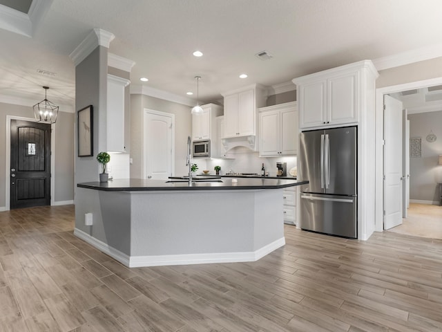 103 Lakeshore Ct, Clute, TX 77531 - kitchen featuring stainless steel appliances, dark countertops, recessed lighting, crown molding, and white cabinetry