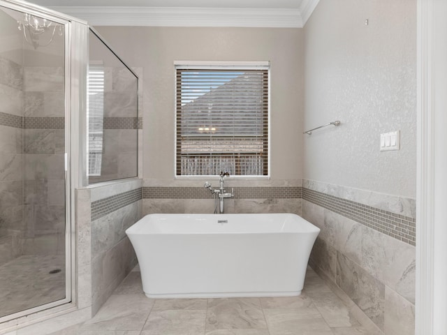 103 Lakeshore Ct, Clute, TX 77531 - bathroom with tile walls, a freestanding tub, crown molding, and a stall shower