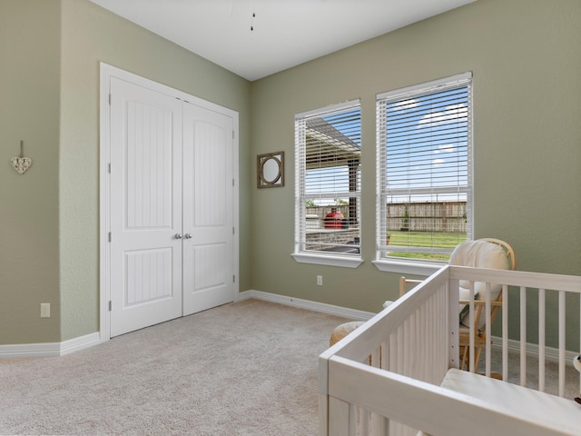 103 Lakeshore Ct, Clute, TX 77531 - bedroom featuring a closet, carpet, and a nursery area