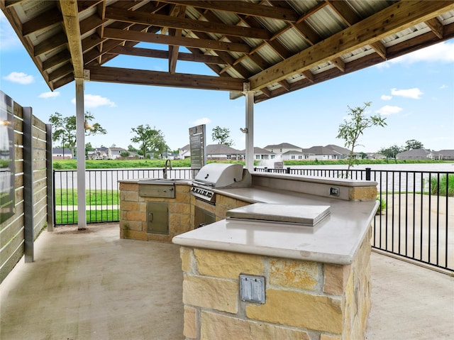 103 Lakeshore Ct, Clute, TX 77531 - view of patio / terrace featuring an outdoor kitchen, a water view, and a residential view