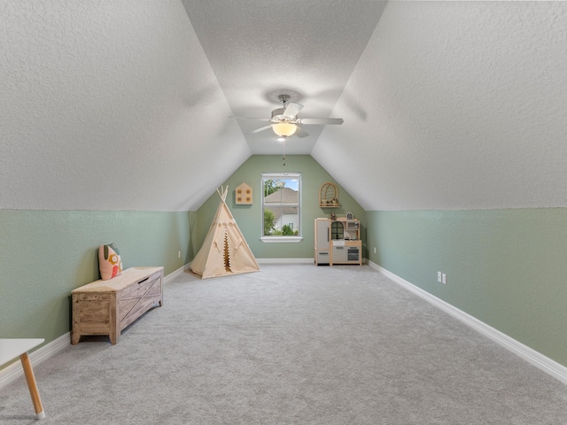 103 Lakeshore Ct, Clute, TX 77531 - playroom with a textured ceiling, ceiling fan, lofted ceiling, and carpet