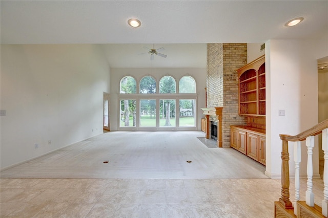 3134 Lake Island Dr, Montgomery, TX 77356 - unfurnished living room featuring ceiling fan, a fireplace, light carpet, and a high ceiling