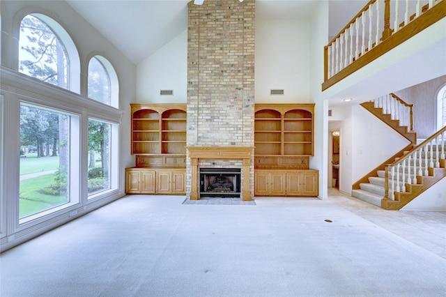 3134 Lake Island Dr, Montgomery, TX 77356 - unfurnished living room with high vaulted ceiling, carpet flooring, a large fireplace, and stairway