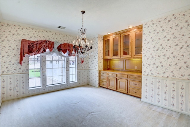 3134 Lake Island Dr, Montgomery, TX 77356 - unfurnished dining area with wallpapered walls, a chandelier, light colored carpet, and crown molding