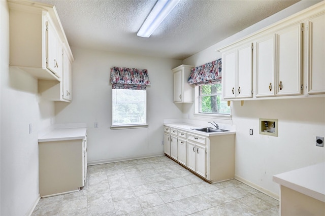 3134 Lake Island Dr, Montgomery, TX 77356 - laundry area with cabinet space, hookup for an electric dryer, a textured ceiling, and hookup for a washing machine