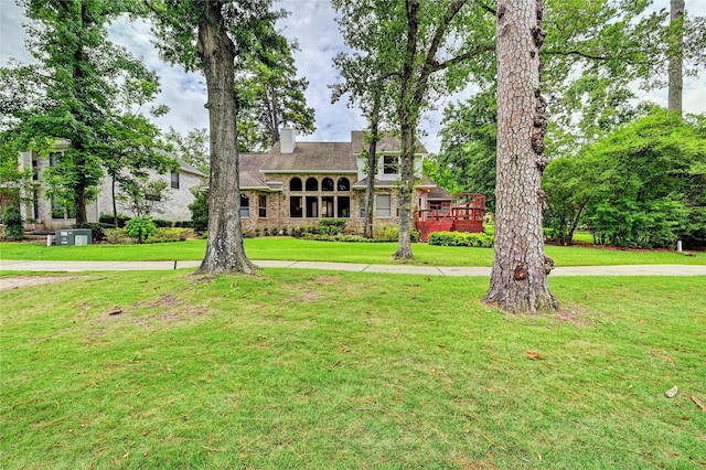 3134 Lake Island Dr, Montgomery, TX 77356 - view of front facade featuring a chimney, stone siding, and a front lawn