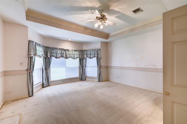 3134 Lake Island Dr, Montgomery, TX 77356 - empty room with ornamental molding, wainscoting, a raised ceiling, wallpapered walls, and a ceiling fan