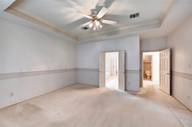 3134 Lake Island Dr, Montgomery, TX 77356 - unfurnished bedroom featuring ornamental molding, a raised ceiling, wainscoting, carpet, and wallpapered walls