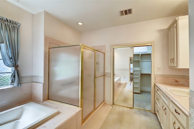3134 Lake Island Dr, Montgomery, TX 77356 - full bathroom featuring a stall shower, vanity, a bath, and a walk in closet