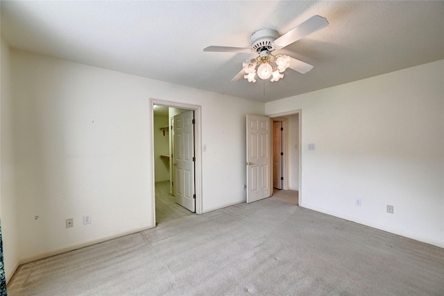 3134 Lake Island Dr, Montgomery, TX 77356 - unfurnished bedroom with light carpet, a spacious closet, and ceiling fan