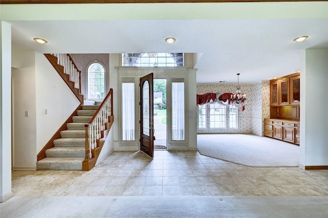 3134 Lake Island Dr, Montgomery, TX 77356 - entryway featuring wallpapered walls, light colored carpet, a chandelier, and stairs
