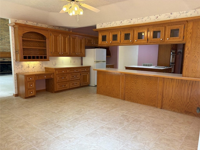 3134 Lake Island Dr, Montgomery, TX 77356 - kitchen featuring brown cabinetry, freestanding refrigerator, a ceiling fan, double oven, and open shelves