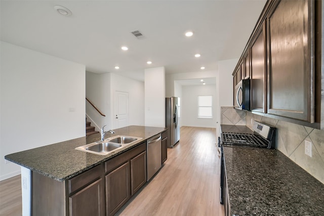 4918 Eldorado Rose Pl, Katy, TX 77493 - kitchen featuring appliances with stainless steel finishes, light wood-style flooring, dark brown cabinetry, and recessed lighting