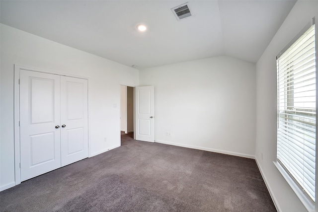 4918 Eldorado Rose Pl, Katy, TX 77493 - unfurnished bedroom featuring dark carpet, multiple windows, lofted ceiling, and a closet