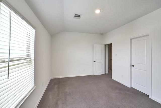 4918 Eldorado Rose Pl, Katy, TX 77493 - unfurnished bedroom featuring multiple windows, dark colored carpet, and vaulted ceiling