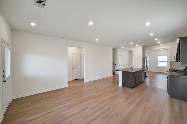 4918 Eldorado Rose Pl, Katy, TX 77493 - kitchen featuring stainless steel appliances, light wood-type flooring, a kitchen island with sink, recessed lighting, and open floor plan