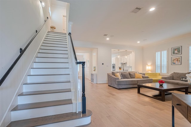 14439 Basalt Ln, Houston, TX 77077 - staircase with crown molding, wood finished floors, and recessed lighting
