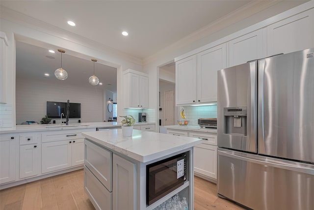 14439 Basalt Ln, Houston, TX 77077 - kitchen featuring stainless steel fridge with ice dispenser, black microwave, crown molding, decorative backsplash, and white cabinetry
