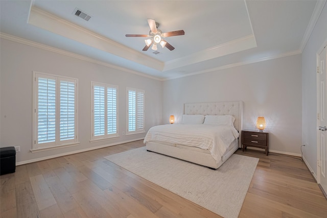 14439 Basalt Ln, Houston, TX 77077 - bedroom featuring a raised ceiling, light wood-style flooring, crown molding, and a ceiling fan