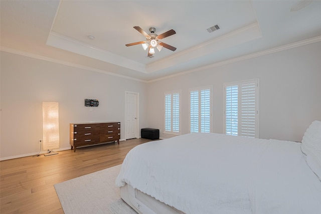 14439 Basalt Ln, Houston, TX 77077 - bedroom featuring a tray ceiling, light wood-style flooring, crown molding, and ceiling fan